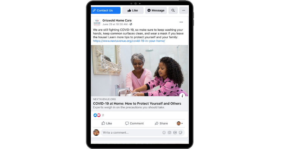A tablet displaying a Facebook post of a grandparent and child washing hands to prevent the spread of COVID-19.