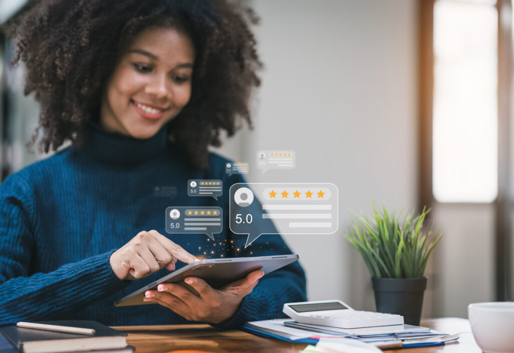 A smiling woman using a tablet with an illustrated overlay of customer review content.